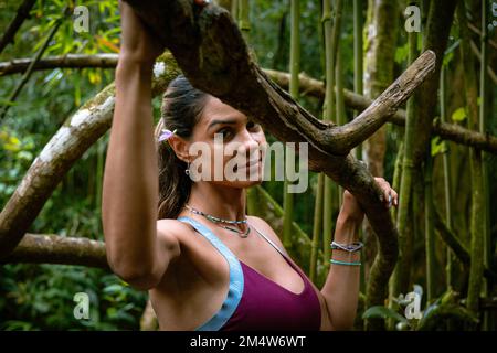 Portrait of a young Caucasian woman on a hiking tour in a forest on O'ahu Island, Hawaii Stock Photo