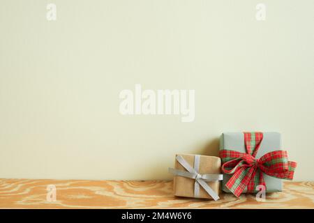 Gift boxes on wooden table. ivory wall background. winter christmas, copy space Stock Photo