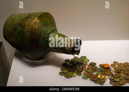 Ancient jug and coins Archaeological artifact on display at the Archaeological Museum, Chania, Crete Stock Photo