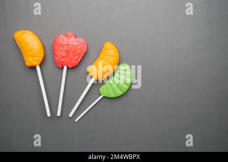 Top view of colorful lollipop on gray background, Stock Photo