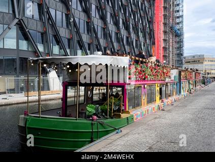 LONDON, UK - MAY 06, 2019:  The colourful Darcie and May Green floating Cafe restaurant on the Paddington Basin canal Stock Photo