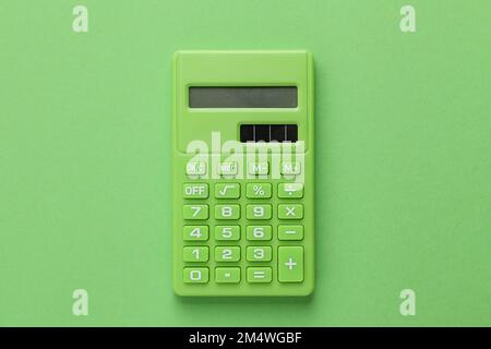 Green Calculator on Green background Stock Photo