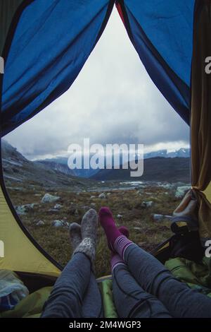 Close up friends in camp at mountain valley concept photo Stock Photo