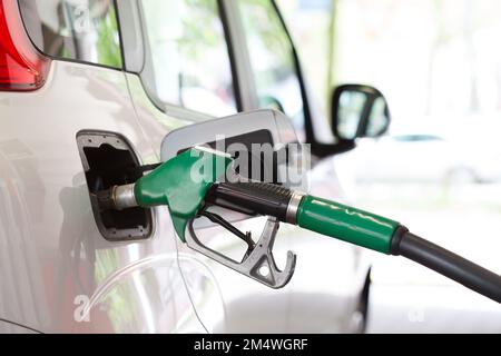 Close up of fuel pump nozzle inside the fuel filler of a car Stock Photo