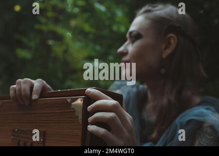 Close up sorceress hands holding wooden box concept photo Stock Photo