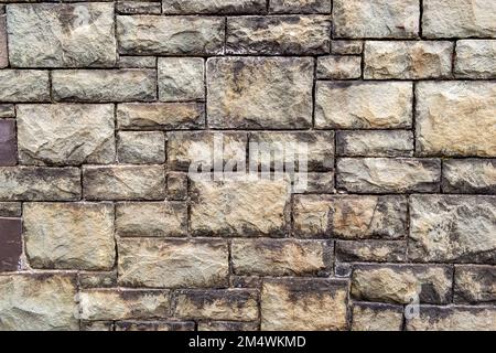 Old dressed stone industrial building wall full frame texture background Stock Photo