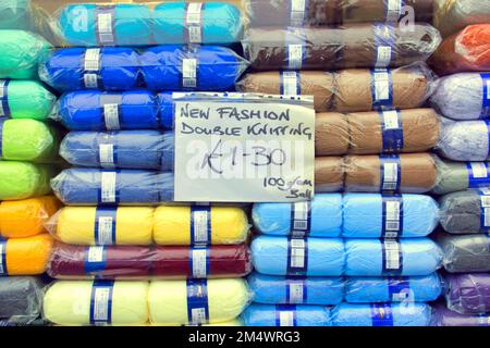 fashion double knitting balls of wool in shop window photographed from the street Stock Photo