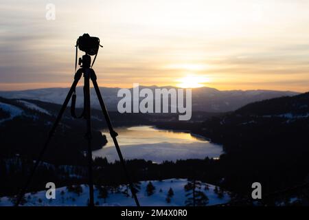 A camera and tripod overlooking Donner Lake, California Stock Photo