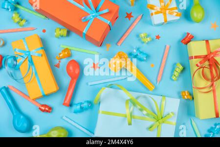 Festive blue background with gift boxes with candles, balloons and serpentine and confetti, birthday or party concept. High quality photo Stock Photo