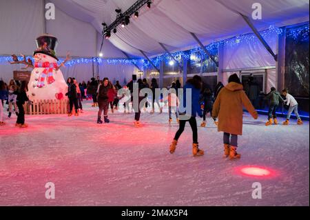 Artificial ice skating rink in El Pilar square during Christmas holidays in Zaragoza, Spain Stock Photo
