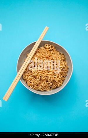 Fresh tasty noodles with vegetables in white big bowl Stock Photo