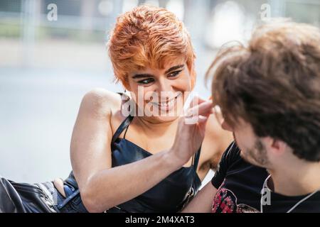 Smiling young woman looking at boyfriend Stock Photo