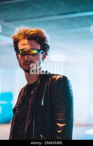 Confident young man wearing smart glasses standing at underpass Stock Photo