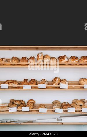 Fresh breads arranged on display at store Stock Photo
