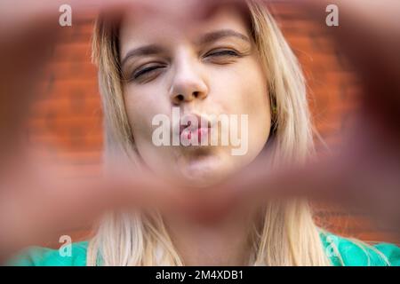 Beautiful young woman puckering lips Stock Photo