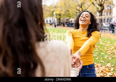 Friends having fun in autumn park Stock Photo