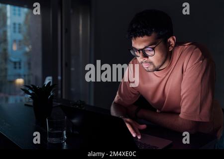 Young man using laptop at home Stock Photo