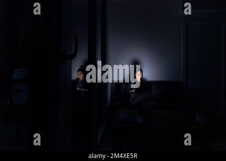 Woman using laptop at home Stock Photo