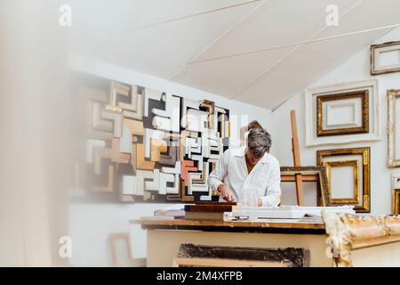 Mature carpenter working in woodshop Stock Photo