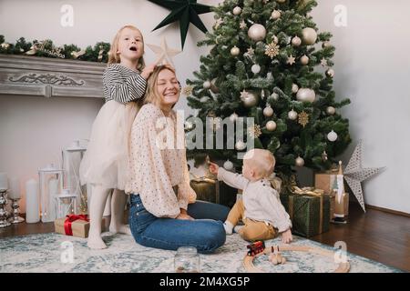 Mother and children having fun at home Stock Photo