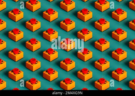 Three dimensional pattern of rows of push buttons flat laid against green background Stock Photo