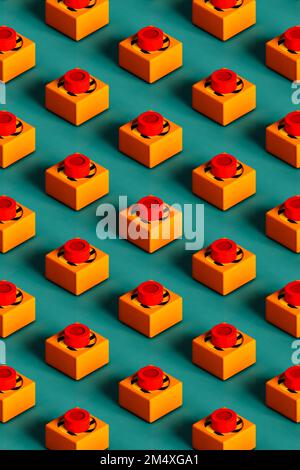 Three dimensional pattern of rows of push buttons flat laid against green background Stock Photo