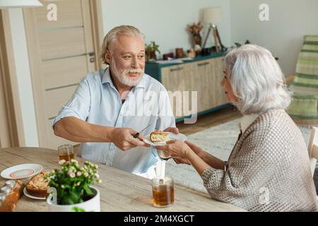 Senior couple having cake and tea at home Stock Photo