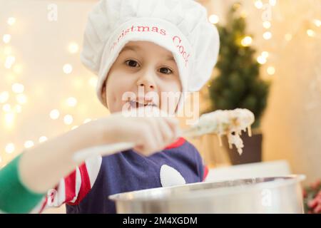 Cute boy preparing gingerbread dough at home Stock Photo