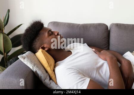 Young man sleeping on sofa at home Stock Photo