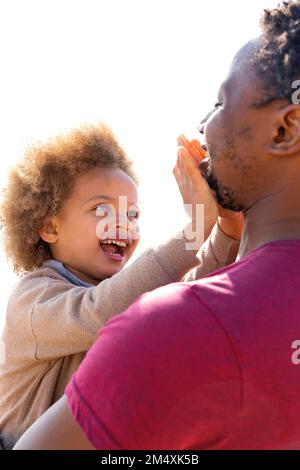 Happy cute daughter playing and having fun with father Stock Photo