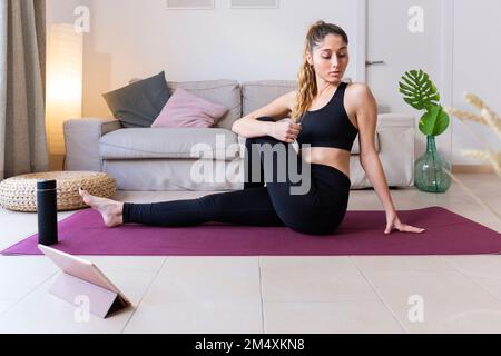 Young woman doing yoga at home Stock Photo
