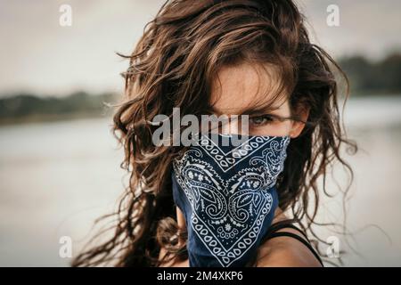 Woman covering face with handkerchief Stock Photo