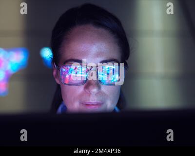 Engineer examining AI technology with reflection on eyeglasses Stock Photo