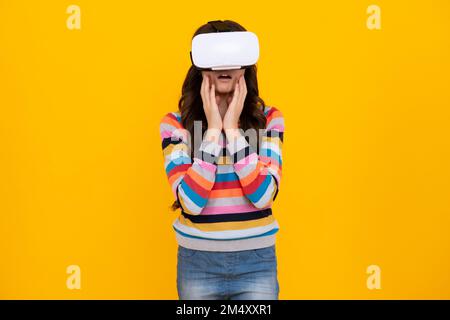 Teen girl wearing virtual reality goggles headset, vr. Connection, technology, new generation, progress concept. Virtual reality, 3D gadget. Shocked Stock Photo