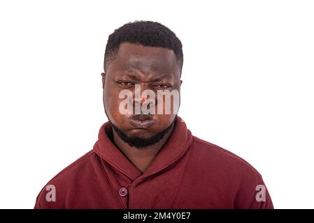 portrait of a handsome young man making grimace with face while puffing up his cheeks and looking at camera. Stock Photo