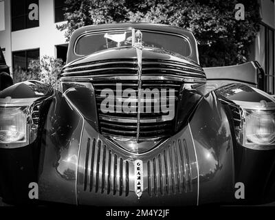 A closeup shot of a shiny black 1939 Graham Sharknose Coupe at Classic Car Show in Woodinville, Washington, in grayscale Stock Photo