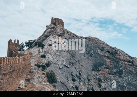 Ancient broken sandstone wall and ble sky. Stock Photo