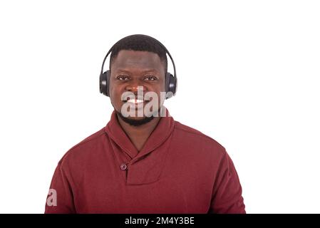 portrait of a handsome young man wearing wireless headphones while smiling. Stock Photo