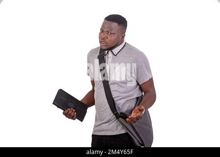 handsome confused young man carrying bag over shoulder and holding digital tablet. Stock Photo