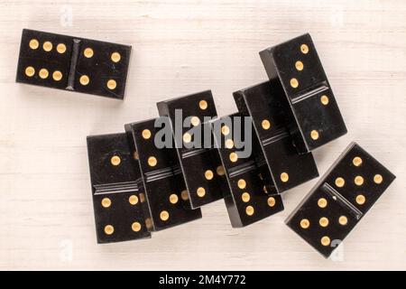 Several dominoes on a wooden table, macro, top view. Stock Photo