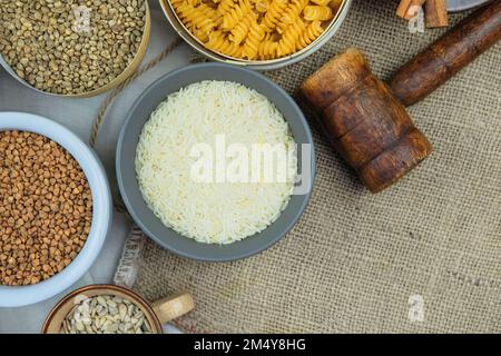 Rice in bowl on a rural background. Vegetarian organic product. Vintage view. Top view. Copy space. Stock Photo