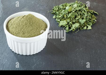 Moringa oleifera medicinal plant - moringa powder and dried leaves. Stock Photo