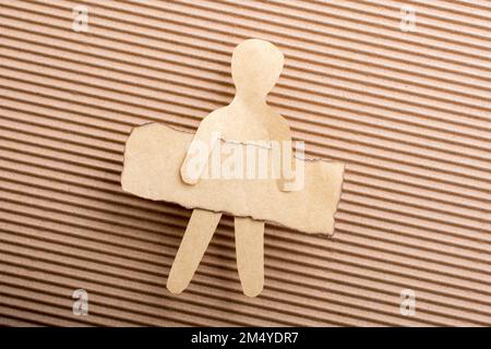 Paper man shape holding burnt note paper in hand Stock Photo