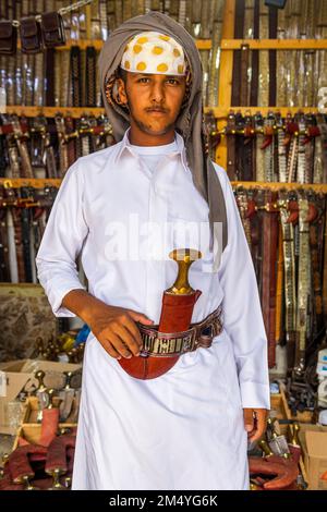 Traditional dressed man in a Store for daqggers or Jambiya, Najran, Kingdom of Saudi Arabia Stock Photo