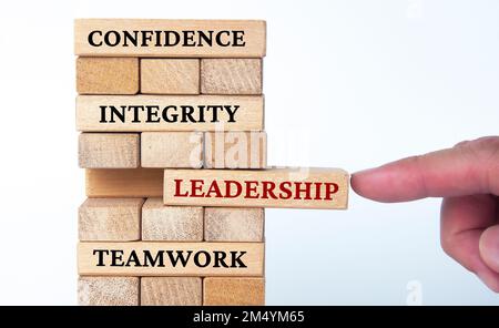 Confidence, integrity, leadership and teamwork text on wood blocks with white background. Business concept. Stock Photo