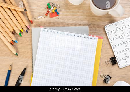 Back to school concept. Top view photo of notepads, pens, sharpeners, ruler, staplers, clips, markers and erasers on wooden table Stock Photo