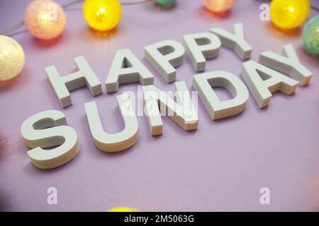 Happy Sunday alphabet letters with LED cotton balls on purple ...