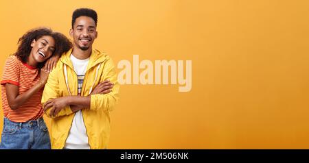 Awesome when boyfriend is best friend. Portrait of charming friendly african american woman leaning on guy touching his shoulder feeling happy they Stock Photo