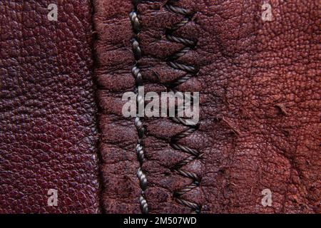 background of red skin and seam closeup Stock Photo