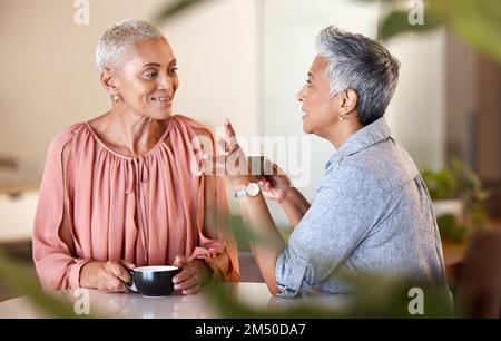 Senior women, friends and talking in cafe, having fun and bonding. Coffee shop, communication and retired elderly females drinking espresso, chatting Stock Photo